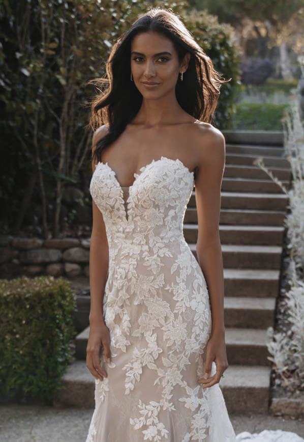 Model wearing a white gown by Allure Bridals