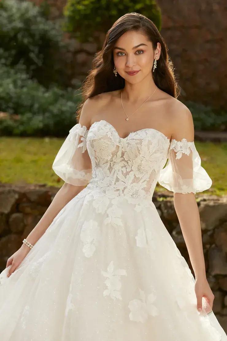 Model wearing a white gown by Allure Bridals