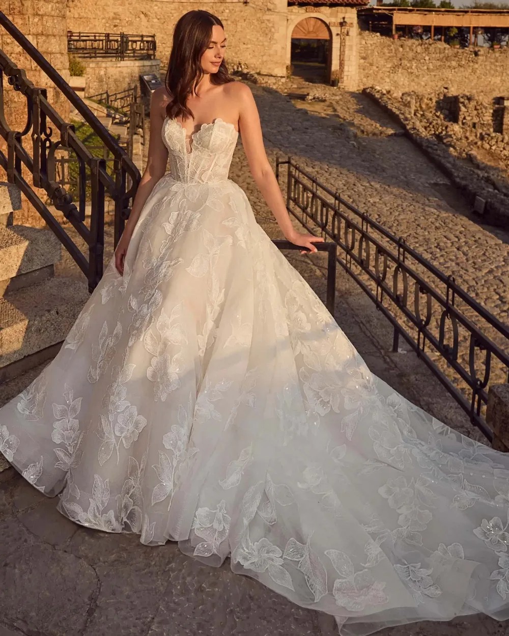 Model wearing a white gown by Kitty Chen